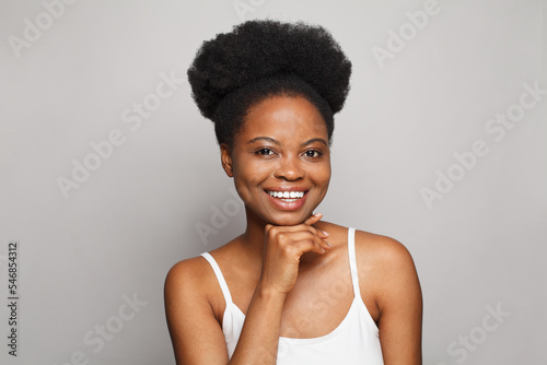 Healthy woman with natural makeup smiling on white background