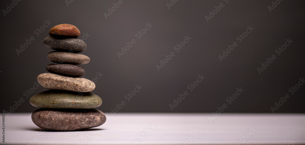 Obraz premium stacked stones against a grey background with copy space