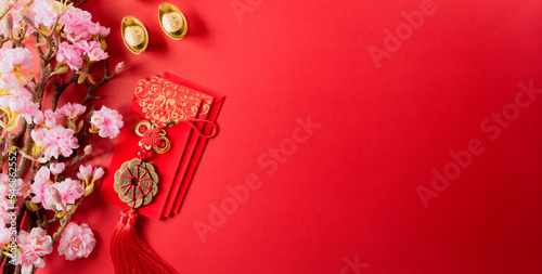 Fotomurale Chinese new year decorations made from red packet, orange and gold ingots or golden lump on a red background