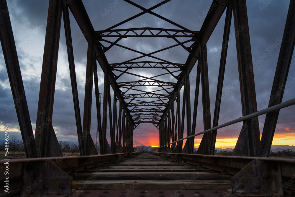 Sunset on the old railway iron bridge