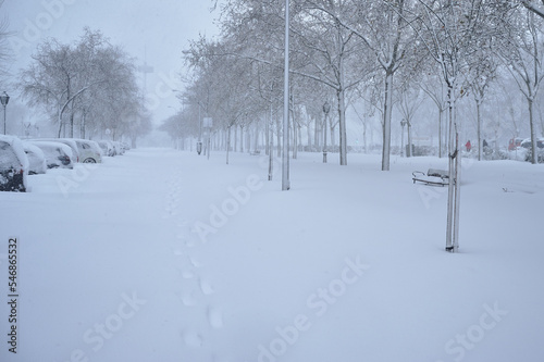 City big avenue covered with snow after a Cyclogenesis blizzard. Cold winter scenes at the city.