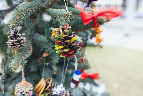 DIY painted pine cone decoration on Christmas tree