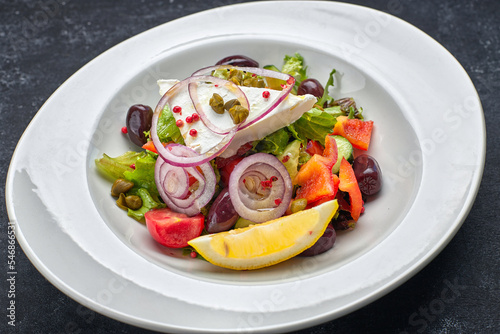 Greek salad with vegetables and cheese on a dark background