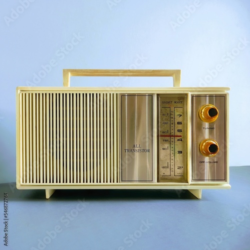 old radio on soft blue wall background
