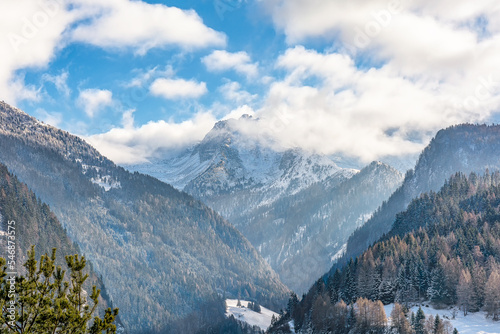 Scenic view of the Italian Alps mountains in winter against dramatic morning sky