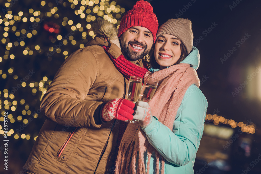 Photo of attractive lady handsome guy hold champagne glass toothy smile magic spirit time garland outdoors
