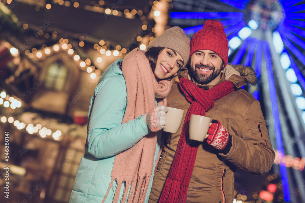 Fototapeta premium Photo of pretty shiny girlfriend boyfriend embracing enjoying hot beverage mugs outdoors urban city market