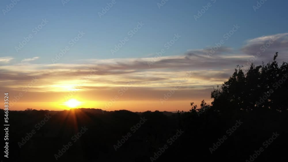 In the night sky countryside establishing shot from drone aerial moving into tree and scene. Sunset in nature and imagination peace and calm for mental health England UK 4K In the night sky countryside establishing shot from drone aerial moving into tree and scene. Sunset in nature and imagination peace and calm for mental health England UK 4K