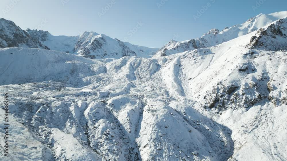 Aerial view of mountain peak in wintertime in Shambulak, Almaty, Kazakhstan. Aerial view of mountain peak in wintertime in Shambulak, Almaty, Kazakhstan.