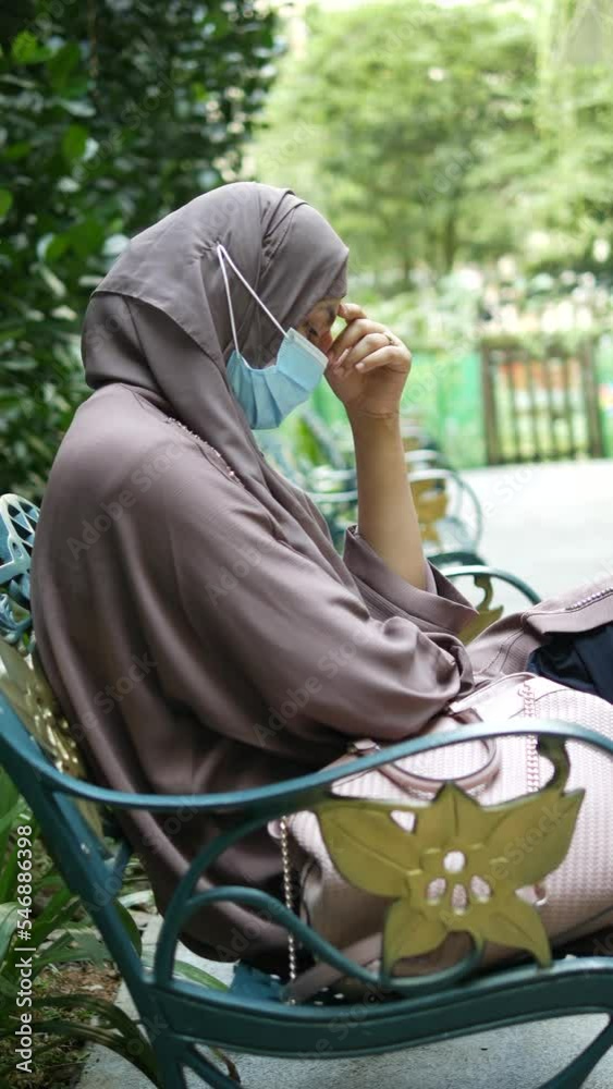 thoughtful muslim woman with flu mask looking away thoughtful muslim woman with flu mask looking away