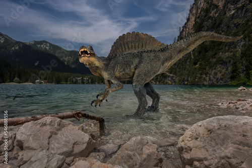 Spinosaurus standing alone into water lake before dinosaur extinction