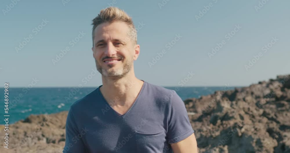 Male tourist walking on volcanic seashore Male tourist walking on volcanic seashore