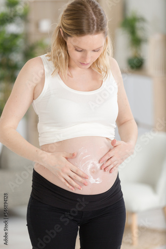 pregnant woman applying moisturiser to her bump Free Download pregnant woman applying moisturiser to her bump - GFXLoad