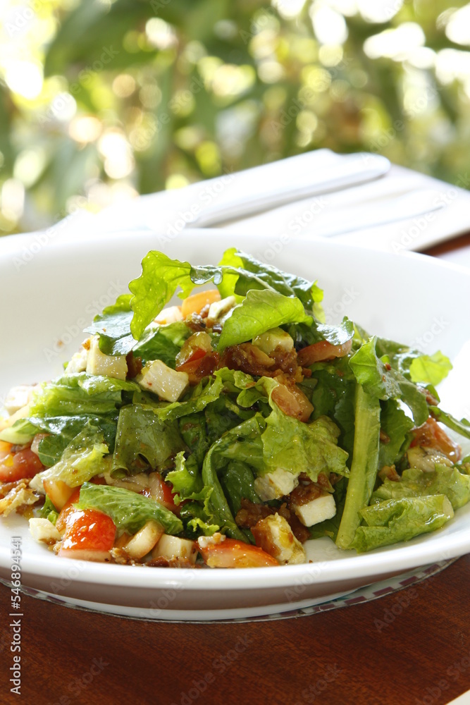 Caesar salad on a wooden table on a sunny day Caesar salad on a wooden table on a sunny day