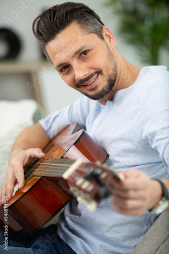 male musician tuning a guitar