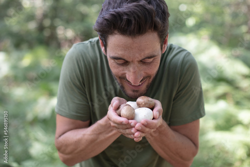 a man holds a mushroom photo