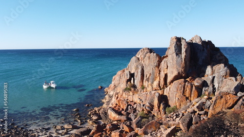 Two boats next to a rock formation in a lagoon. Location Dunsborough in South-west Western Australia. Beautiful blue clear water.	