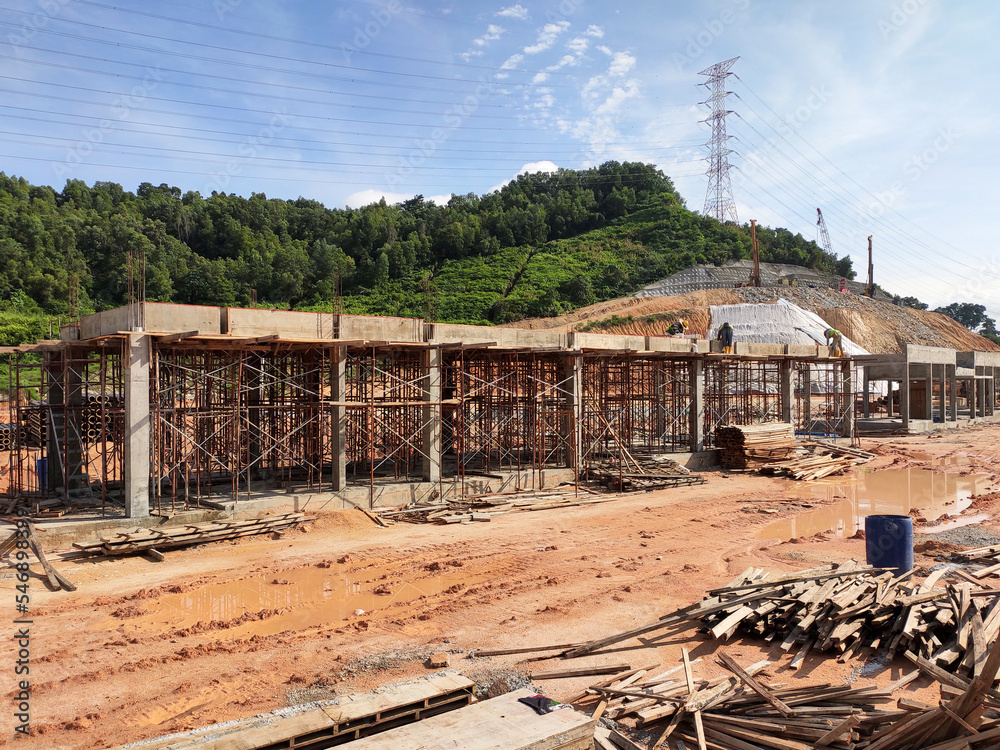 Fototapeta premium MELAKA, MALAYSIA - MARCH 4, 2021: The building structure is made of reinforced concrete still under construction. This reinforced concrete mold is made of timber and plywood formwork.