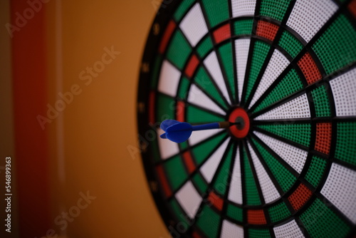 darts in the center of a dartboard