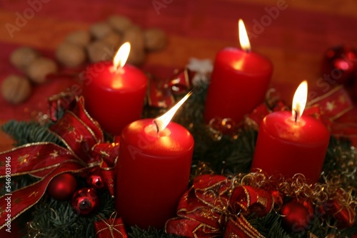 Vertical shot of red lighted Christmas candles for holidays