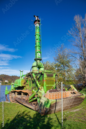 Billede på lærred Komatsu amphibious dozer on a river bank in autumn day