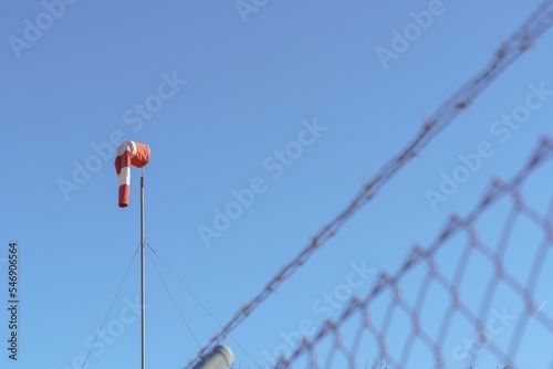 wind mage on a calm day in the foreground a chain link fence photo