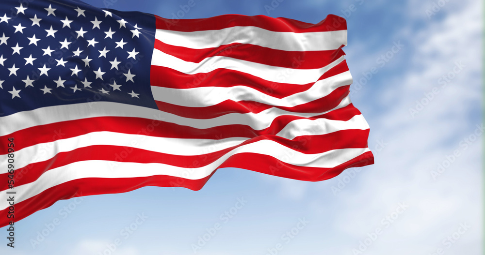 Fototapeta premium The national flag of the United States of America waving in the wind on a clear day. Patriotism concept. 3D illustration