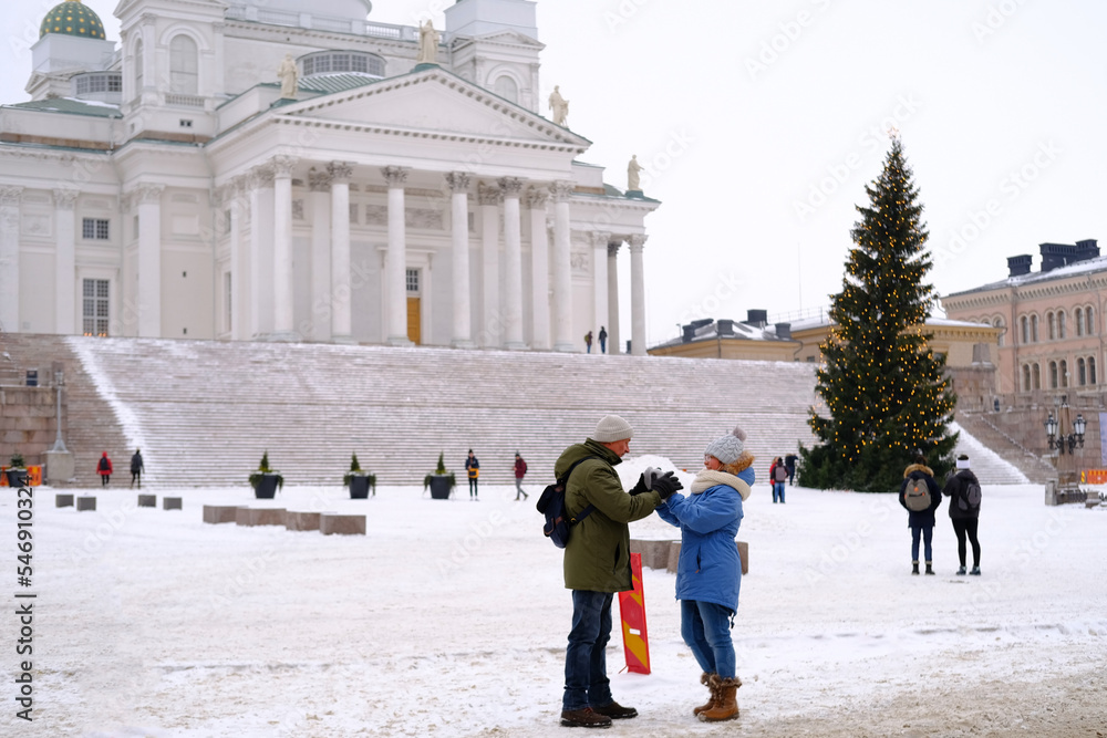 view of Helsinki Cathedral and Statue Of Emperor Alexander II Of Russia on, people walking along winter street, concept holiday, pre-holiday chores citizens, Helsinki, Finland - January 2022