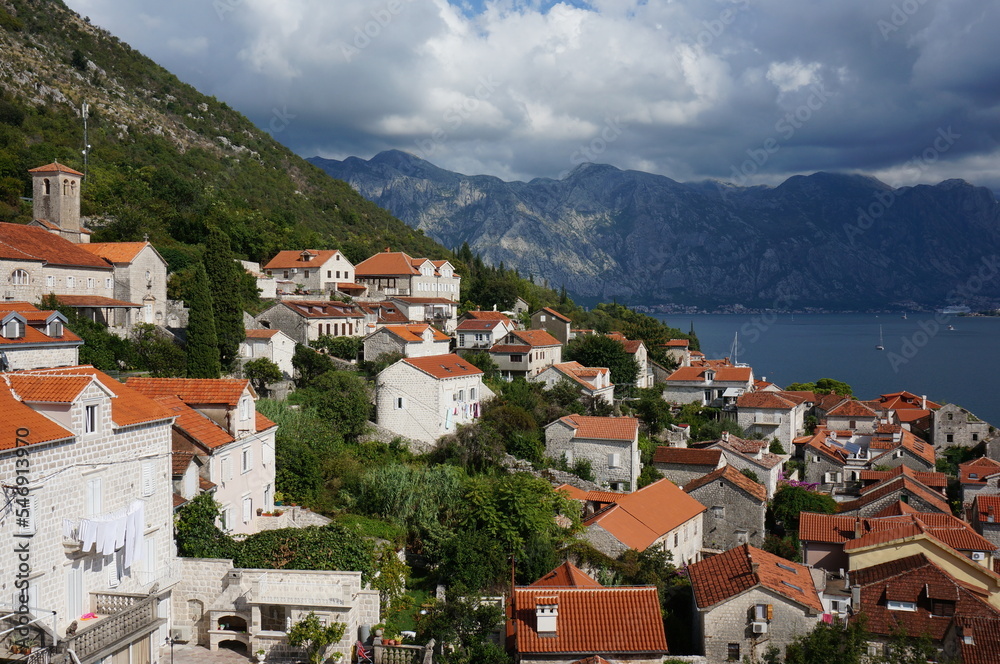 Houses on the steep mountain slopes of the Bay of Kotor. Perast, Montenegro.