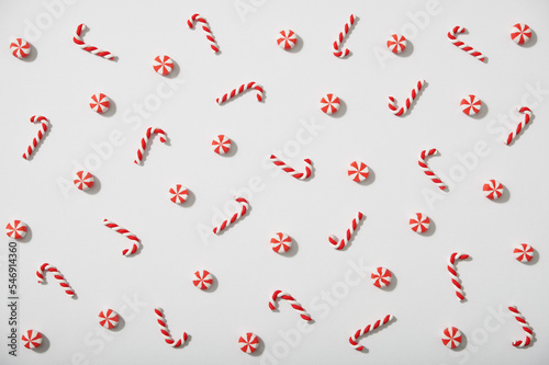 Christmas pattern made of decorative candy canes on white background