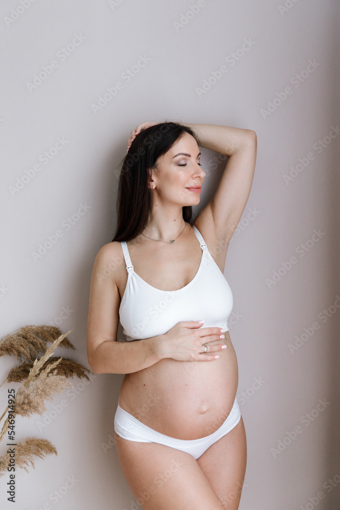 Pregnancy photo session at home, in the kitchen, in the room on the bed, by the window and in the bathroom, brushing your teeth, putting your hands on your tummy and making cheesecakes from flour Pregnancy photo session at home, in the kitchen, in the room on the bed, by the window and in the bathroom, brushing your teeth, putting your hands on your tummy and making cheesecakes from flour