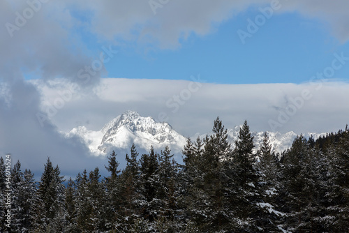 Snowy mountains and an impressive rock wall in High Tatra Mountains - the mountain range and national park in Slovakia