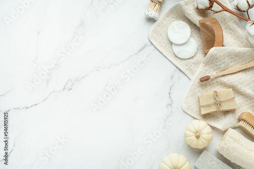 Background for cosmetics. Natural eco cosmetics on a gray background. A wooden brush with a cotton towel and natural soap.
