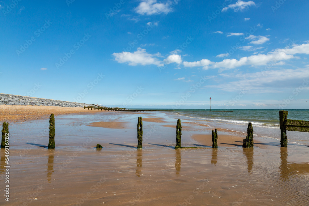 Looking along the beach at low tide, at Camber Sands in Sussex