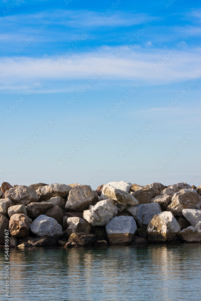 Dam with stone blocks for protection from sea storms - image with copy space Dam with stone blocks for protection from sea storms - image with copy space