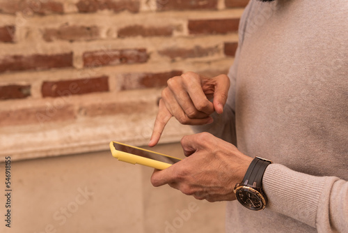 Close-up image of a man checking the notifications on your handset using his little finger.
