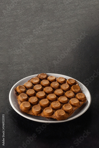 Canvas Print Hong Kong chocolate bubble waffle on dark background with copy space