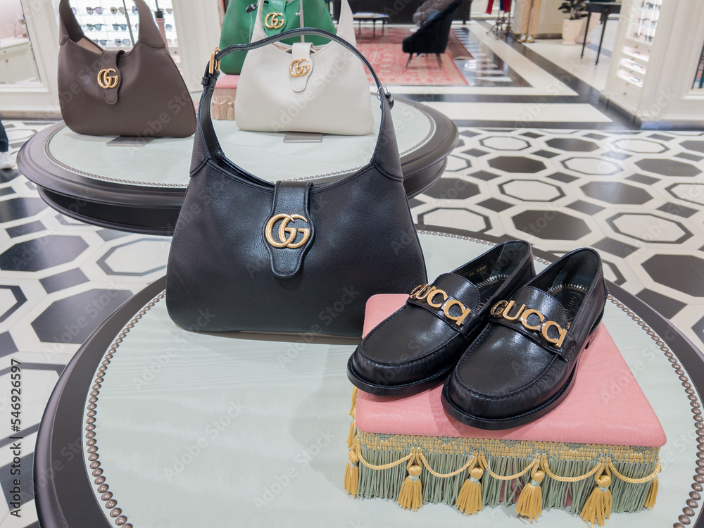Shoes And Handbag In A Display Of A Luxury Store Stock Photo