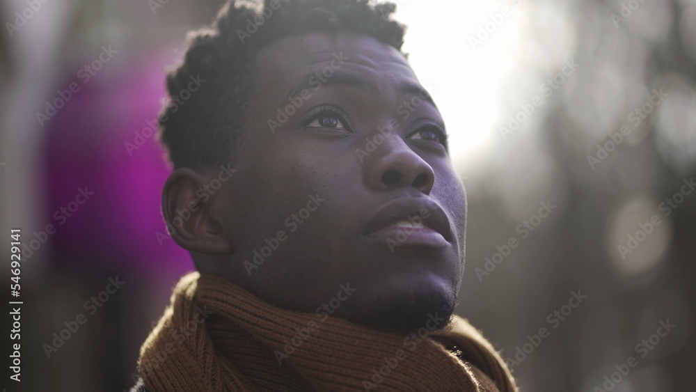 Contemplative African young man face looking up at the sky Contemplative African young man face looking up at the sky