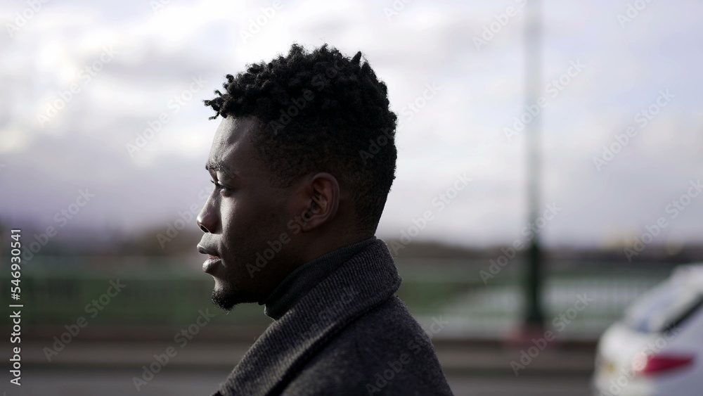 Confident young black man walking forward outside in city, tracking shot Confident young black man walking forward outside in city, tracking shot