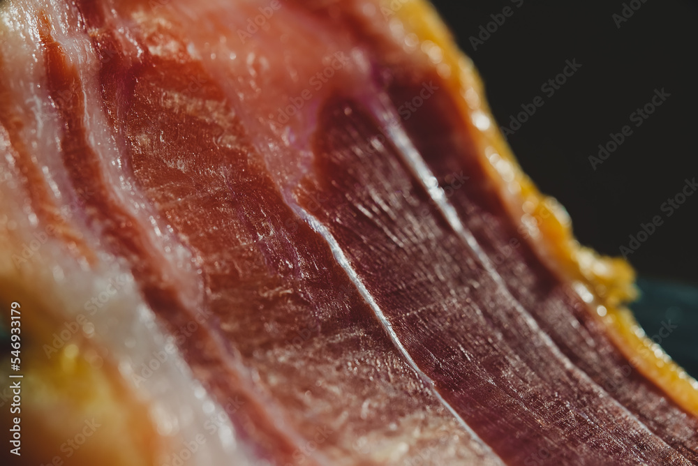 Dry-cured spanish ham Jamon. Close-up view. Dry-cured spanish ham Jamon. Close-up view.
