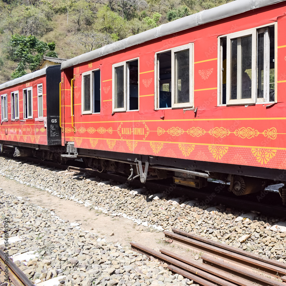 Toy Train moving on mountain slopes, beautiful view, one side mountain, one side valley moving on railway to the hill, among green natural forest. Toy train from Kalka to Shimla in India, Indian Train Toy Train moving on mountain slopes, beautiful view, one side mountain, one side valley moving on railway to the hill, among green natural forest. Toy train from Kalka to Shimla in India, Indian Train