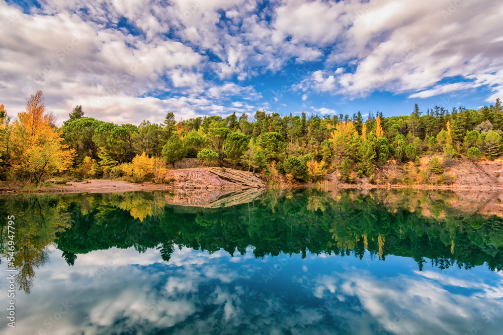 Scenic view of mirror like reflection of Carces lake in south of France in autumn colors against dramatic sky Scenic view of mirror like reflection of Carces lake in south of France in autumn colors against dramatic sky