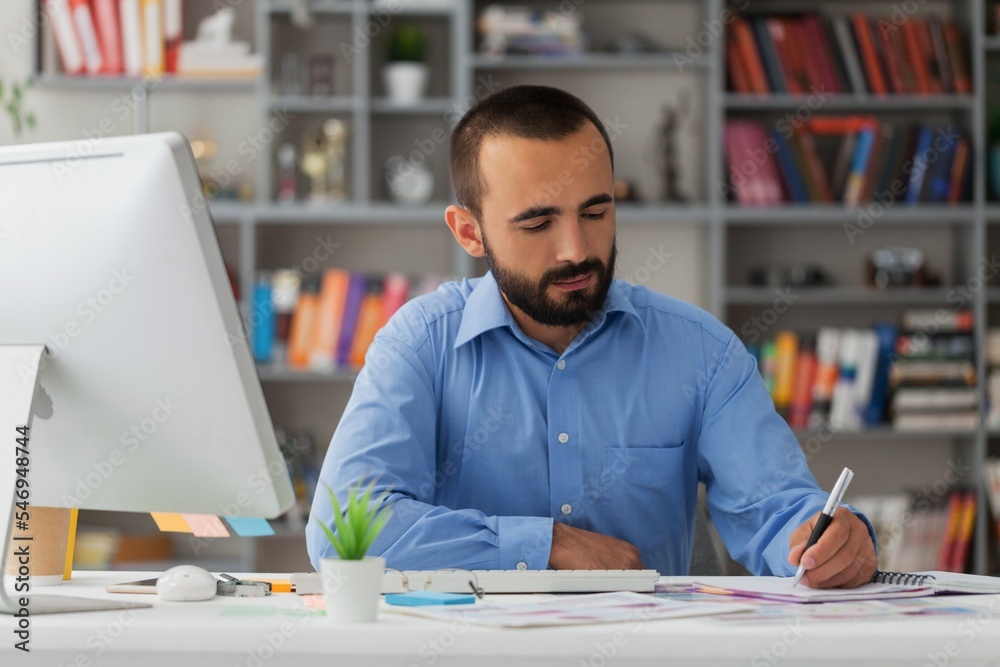 Bearded businessman working on computer in office. Video online webinar. Bearded businessman working on computer in office. Video online webinar.