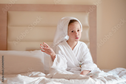 little girl in a hotel in a white coat