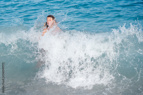 little girl swims in the sea on an inflatable ring. sea ​​waves. family vacation concept