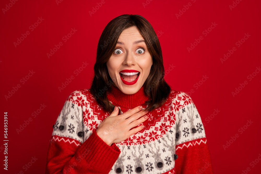 Portrait of speechless cute girlish woman with bob hairdo dressed red sweater hold arm on chest staring isolated on red color background Portrait of speechless cute girlish woman with bob hairdo dressed red sweater hold arm on chest staring isolated on red color background