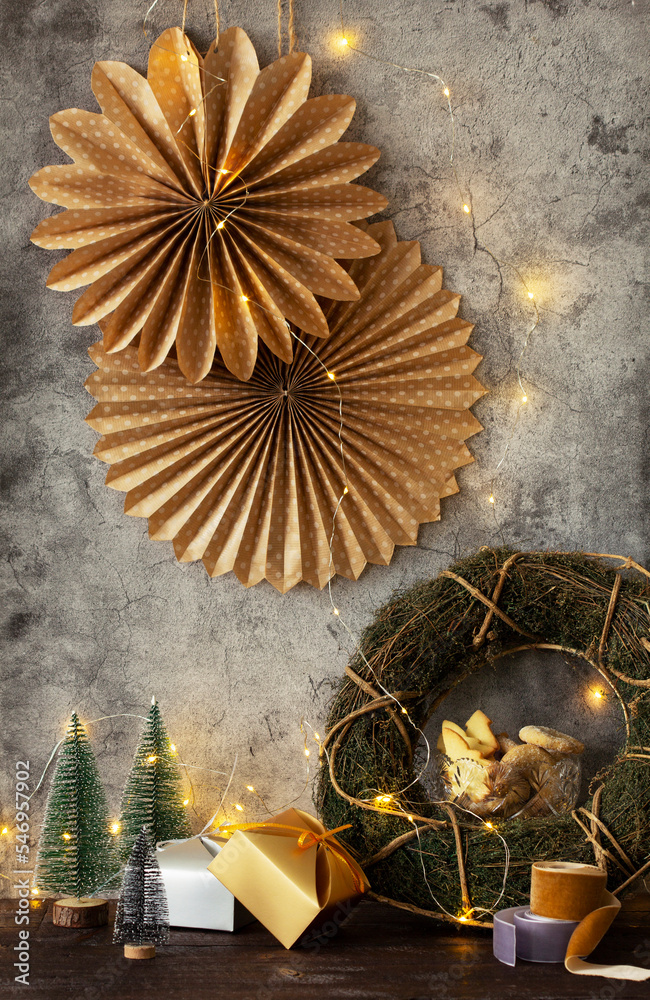 Winter holiday concert, paper stars, wreath, fir trees, cookies and garland on a gray background.