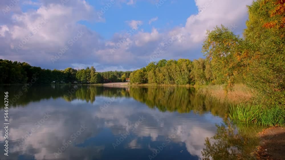 Natural landscape of the lake, high definition, the movement of waves against the background of the autumn forest. The reflection of a storm clouds on the ripples of water. Germany. Natural landscape of the lake, high definition, the movement of waves against the background of the autumn forest. The reflection of a storm clouds on the ripples of water. Germany.