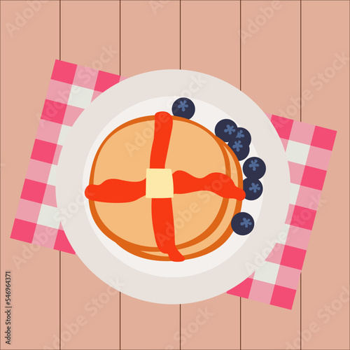 Simple flat traditional american breakfast brown pancakes with melted butter, honey syrup and blueberries on a white plate, red napkin and wooden table background